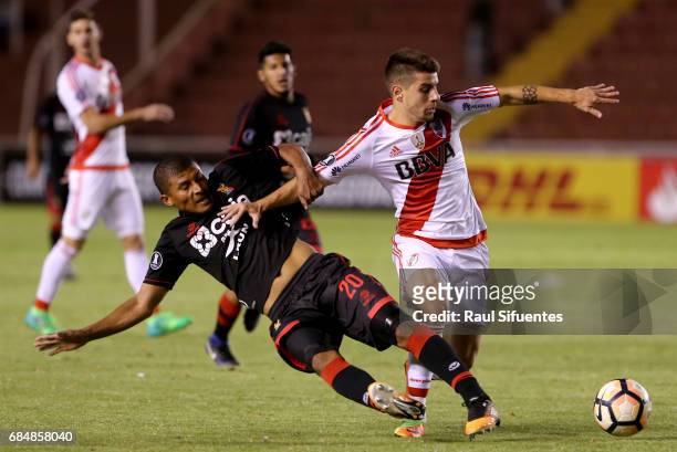 Tomas Andrade of River Plate struggles for the ball with Minzum Quina of FBC Melgar during a group stage match between FBC Melgar and River Plate as...