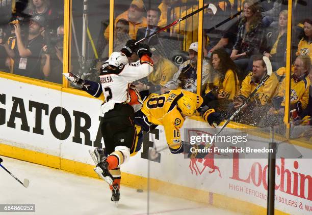 Kevin Bieksa of the Anaheim Ducks checks James Neal of the Nashville Predators during the first period in Game Four of the Western Conference Final...