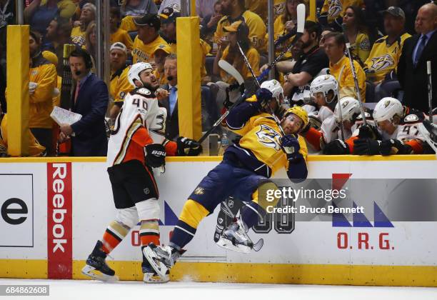 Jared Boll of the Anaheim Ducks checks Yannick Weber of the Nashville Predators during the second period in Game Four of the Western Conference Final...