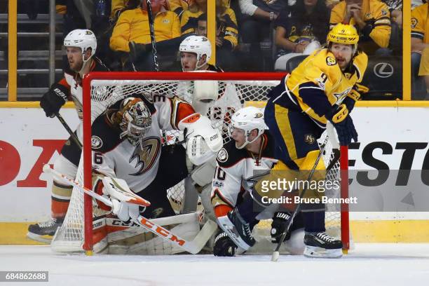 John Gibson and Corey Perry of the Anaheim Ducks get tangled in the goal during the second period against the Nashville Predators in Game Four of the...