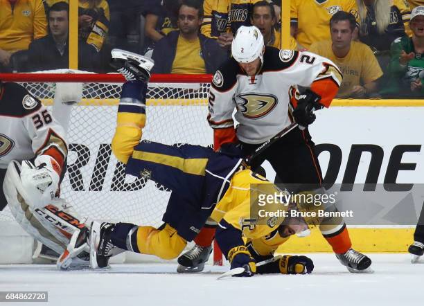 Mike Fisher of the Nashville Predators falls on the ice as Kevin Bieksa of the Anaheim Ducks looks on during the second period in Game Four of the...