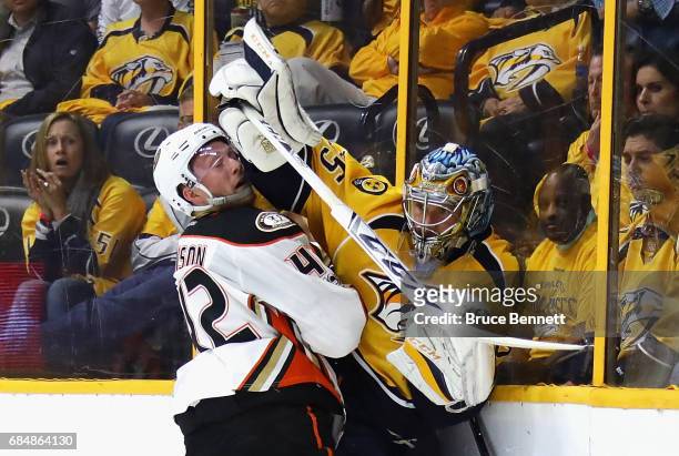 Pekka Rinne of the Nashville Predators battles along the boards with Josh Manson of the Anaheim Ducks during the second period in Game Four of the...