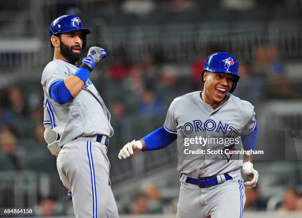 Marcus Stroman of the Toronto Blue Jays is congratulated by Jose Bautista after hitting a fourth inning solo home run against the Atlanta Braves at...