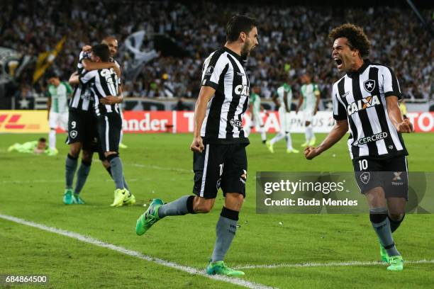 Rodrigo Pimpao and Camilo of Botafogo celebrate a scored goal against Atletico Nacional during a match between Botafogo and Atletico Nacional as part...