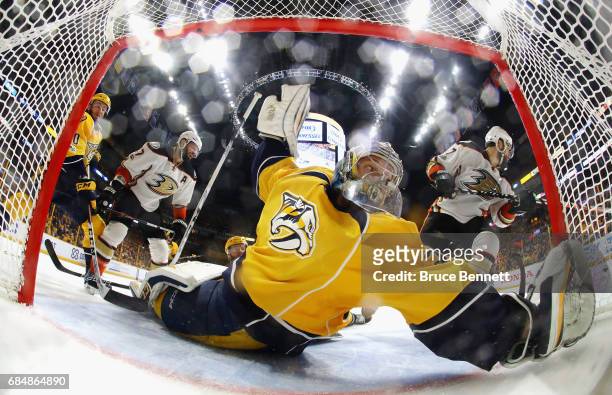 Pekka Rinne of the Nashville Predators looks back as he tends goal against Ryan Kesler and Andrew Cogliano of the Anaheim Ducks during the second...