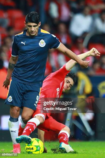 Efrain Velarde of Toluca fights for the ball with Alan Pulido of Chivas during the semifinals first leg match between Toluca and Chivas as part of...