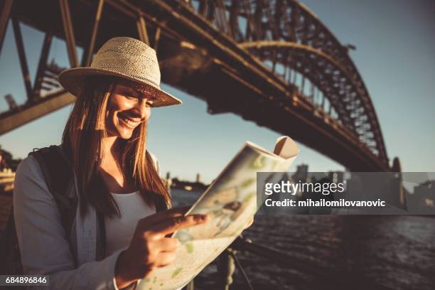 woman traveler holding city map - tourism australia stock pictures, royalty-free photos & images