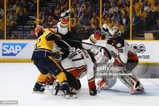 Josh Manson of the Anaheim Ducks falls over Mike Fisher of the Nashville Predators and Hampus Lindholm of the Anaheim Ducks during the third period...