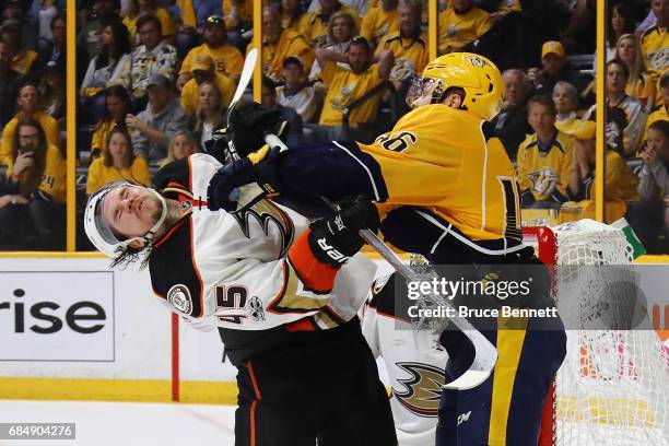 Pontus Aberg of the Nashville Predators hits Sami Vatanen of the Anaheim Ducks during the third period in Game Four of the Western Conference Final...