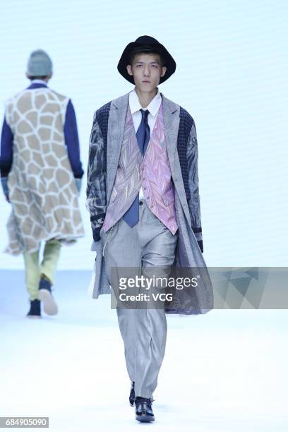 Model showcases designs designed by graduates of Beijing Institute of Fashion Technology and Durban University of Technology on the runway during day...