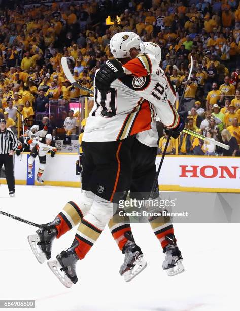 Corey Perry of the Anaheim Ducks celebrates with Nate Thompson after scoring a goal during the overtime period to defeat the Nashville Predators 3-2...