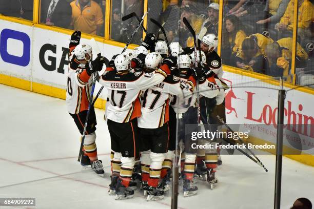 Corey Perry of the Anaheim Ducks celebrates with teammates after scoring a goal during the overtime period to defeat the Nashville Predators 3-2 in...