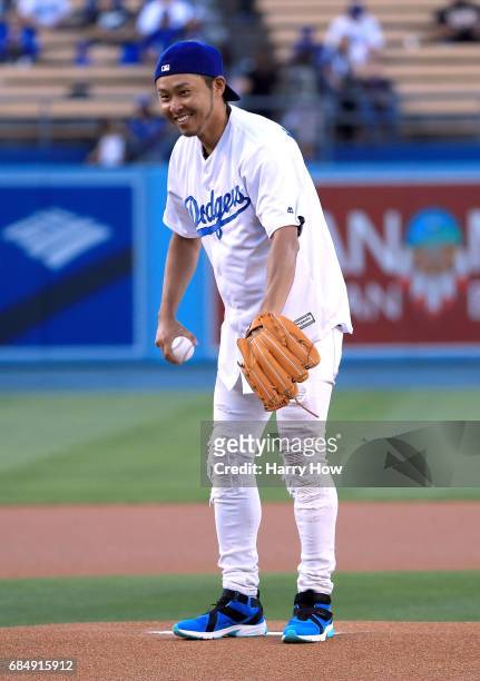 Olympic swimmer Kosuke Kitajima of Japan prepares to throw out a ceremonial first pitch before the game against the Miami Marlins at Dodger Stadium...