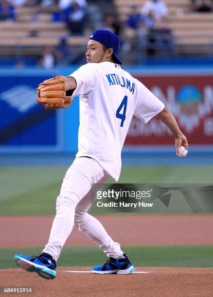 Olympic swimmer Kosuke Kitajima of Japan throws out a ceremonial first pitch before the game against the Miami Marlins at Dodger Stadium on May 18,...
