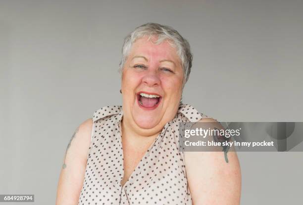 a portrait of a senior woman in her 60's - old woman tattoos stock pictures, royalty-free photos & images