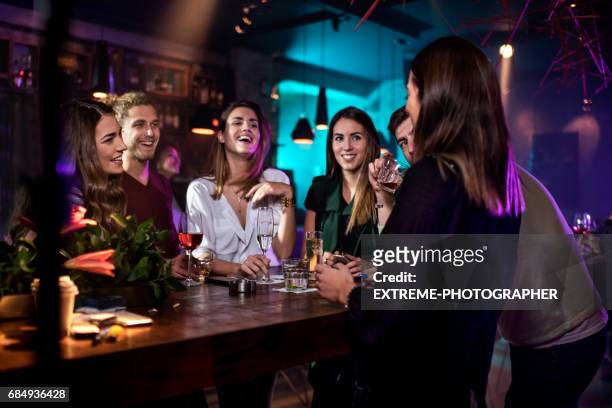 group of people in the bar - bar table stock pictures, royalty-free photos & images