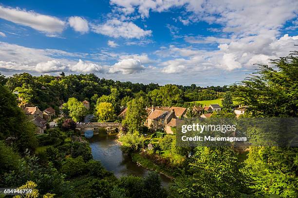 the sarthe river and the village - normandie stock-fotos und bilder