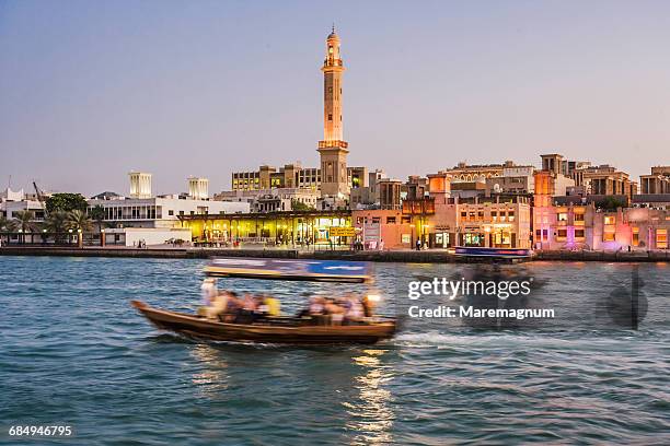 some abra (water taxis) on dubai creek - dubai creek stock pictures, royalty-free photos & images