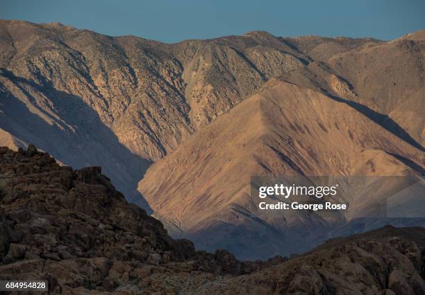 The White Mountains are viewed at sunset from Highway 395 on April 6 in Lone Pine, California. Owens Valley is an arid valley in eastern California,...