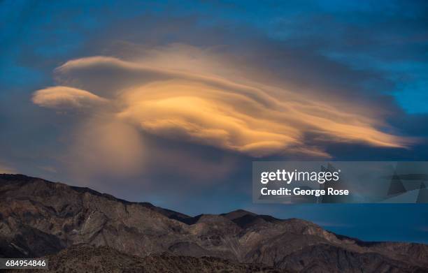 An unusual lenticular cloud forms due to high winds over the White Mountain on April 6 near Lone Pine, California. Owens Valley is an arid valley in...