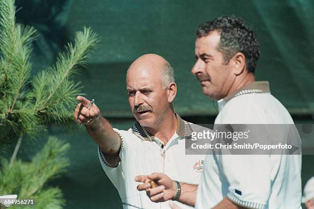 English golfer and non-playing captain of Team Europe, Mark James pictured left with vice captain Sam Torrance as they discuss tactics during...