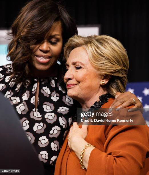 American First Lady Michelle Obama introduces politician and Democratic presidential candidate Hillary Clinton on stage during Clinton's campaign...