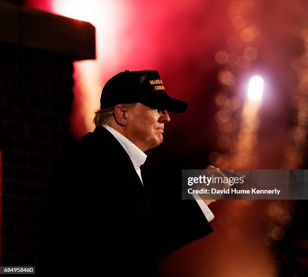 Profile of American real estate developer and presidential candidate Donald Trump as he holds up a clenched fist during a campaign rally at the...