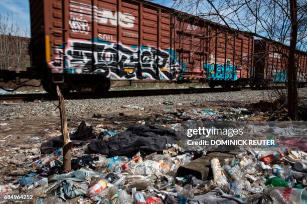 Freight cars rumble past a heroin encampment in the Kensington neighborhood of Philadelphia, Pennsylvania, on April 10, 2017. In North Philadelphia,...