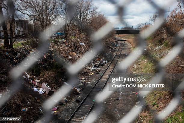 Household trash and empty needle wrapper paper is seen next to rail road tracks near a heroin encampment in the Kensington neighborhood of...