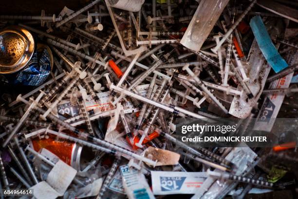 Discarded needles are seen at a heroin encampment in the Kensington neighborhood of Philadelphia, Pennsylvania, on April 7, 2017. In North...