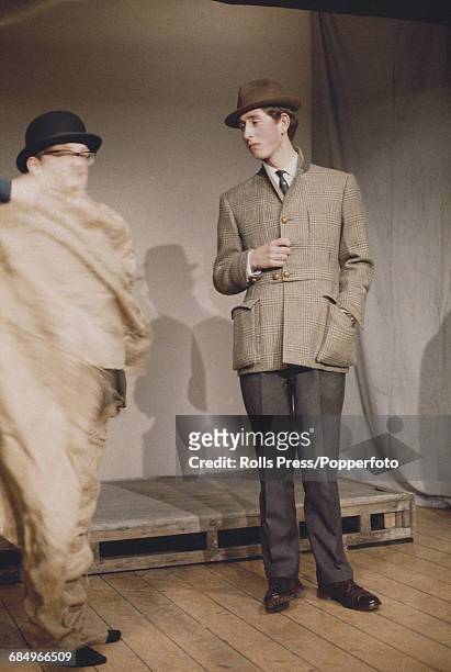 Prince Charles, dressed in tweed jacket and hat, takes part in a sketch for the Trinity College revue called 'Quiet Flows the Don' at Cambridge...