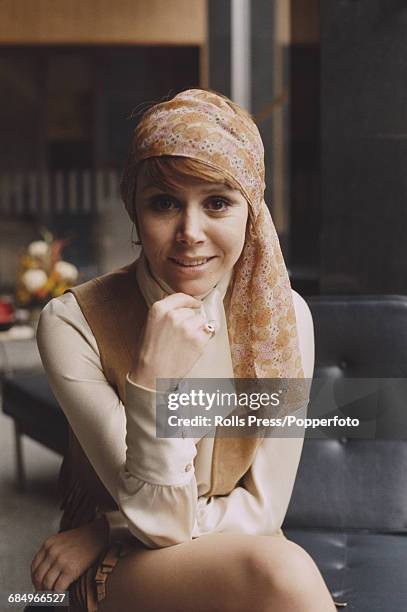 English actress Judy Carne who stars in the American television series 'Rowan & Martin's Laugh-In', posed wearing a headscarf in Elstree,...