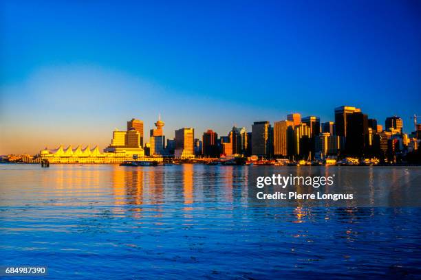 vancouver skyline at sunset from stanley park, british columbia, canada - canada place stock pictures, royalty-free photos & images