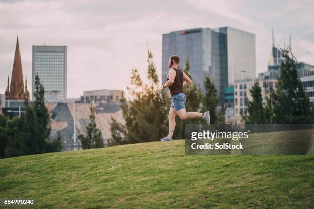 jogging in the park - melbourne city training session stock pictures, royalty-free photos & images