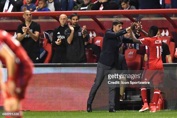 Chicago Fire head coach Veljko Paunovic congratulates Chicago Fire forward David Accam during a game against the Seattle Sounders and the Chicago...