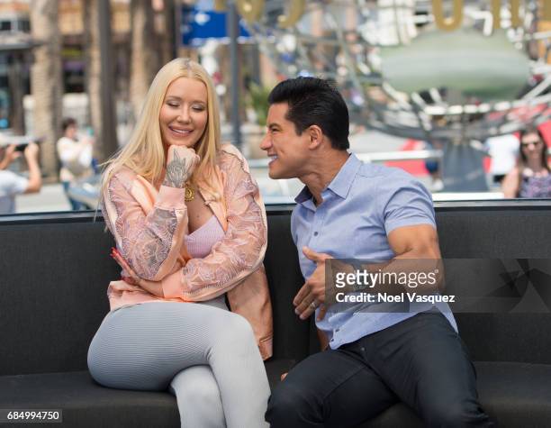 Mario Lopez jokes around with Iggy Azalea at "Extra" at Universal Studios Hollywood on May 18, 2017 in Universal City, California.