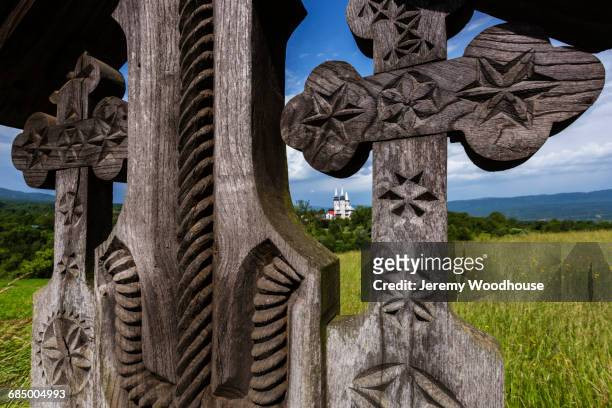 ornate wooden cross in field - maramureș stock pictures, royalty-free photos & images