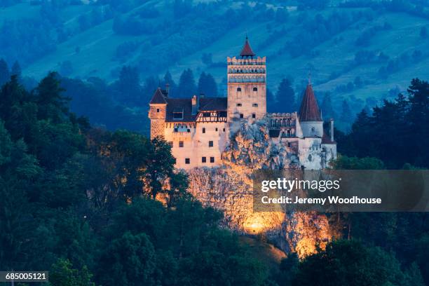 illuminated castle on hill, bran, transylvania, romania - turret fotografías e imágenes de stock
