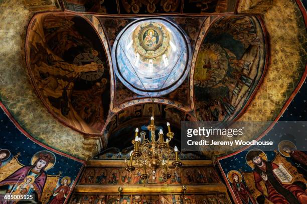 chandelier hanging from ornate church ceiling - sinaia stockfoto's en -beelden