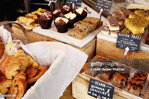 independent coffee shop with display of vegan and gluten-free cakes - gluten free stock pictures, royalty-free photos & images