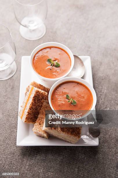 sliced grilled cheese sandwich and tomato soup - tomato soup ストックフォトと画像