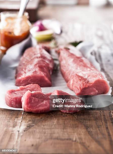 raw pork tenderloin on butcher paper - tenderloin filetsteak stock-fotos und bilder