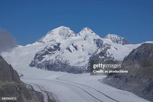 snowy mountain road, aletsch glacier, canton graubunden, switzerland - kanton graubünden stock pictures, royalty-free photos & images