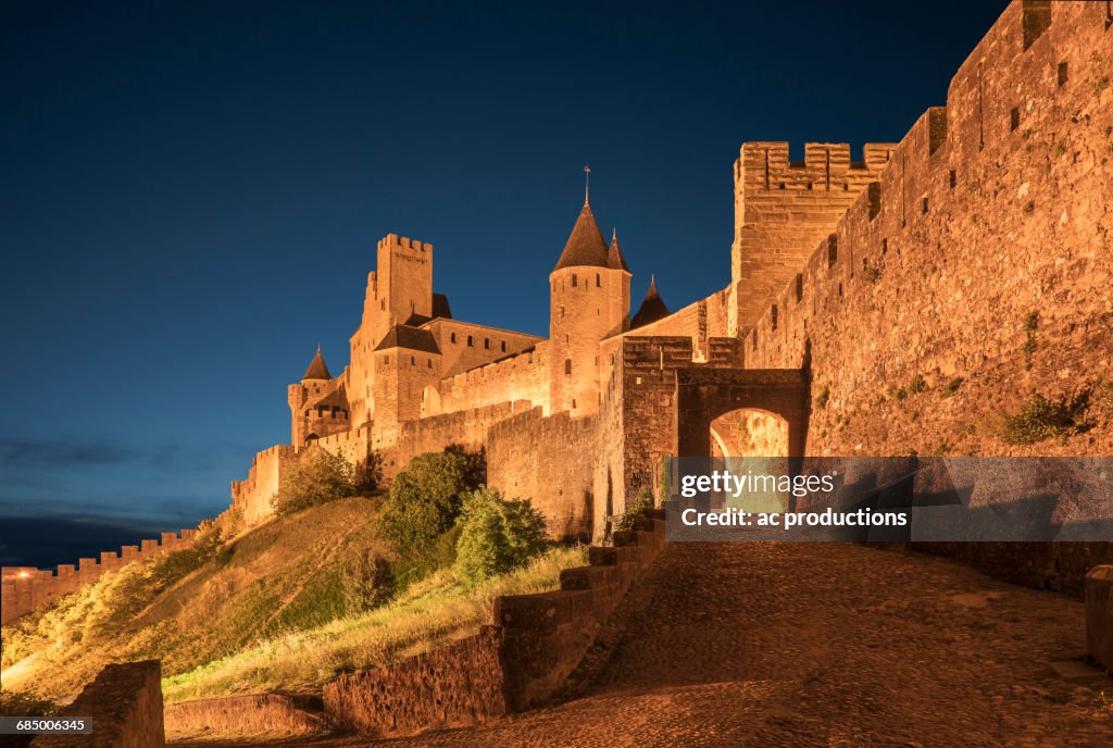 Road to castle at night in Carcassonne, Languedoc-Roussillon, France