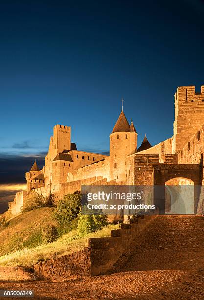 road to castle at night in carcassonne, languedoc-roussillon, france - carcassonne imagens e fotografias de stock