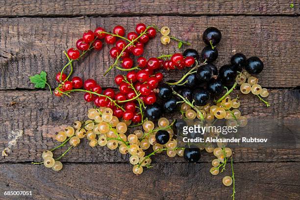 fresh berries on wooden table - currant fruit stock pictures, royalty-free photos & images
