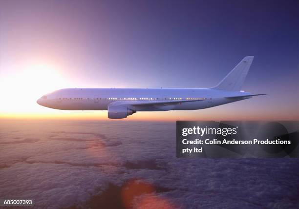 airplane flying above clouds at sunset - airplane side view stock pictures, royalty-free photos & images