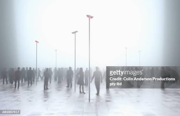 silhouette of crowd under security surveillance - zielgruppe stock-fotos und bilder