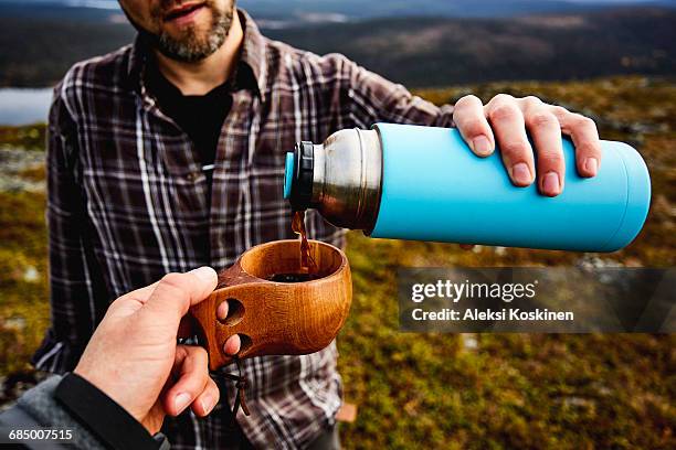 hikers having coffee on cliff top, keimiotunturi, lapland, finland - hot drink stock pictures, royalty-free photos & images