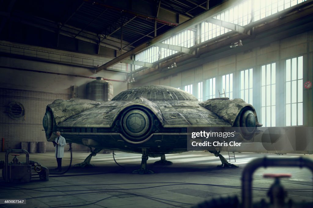 Scientist researching spaceship in hangar